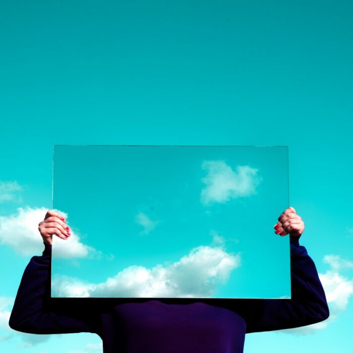 man in black suit jacket raising his right hand